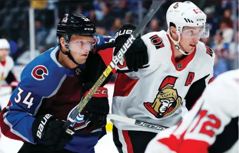  ?? DAVID ZALUBOWSKI/ AP PHOTO ?? Colorado centre Carl Soderberg grapples with Ottawa centre Matt Duchene as they pursue the puck in the first period of Friday’s game in Denver, which the Avalanche won 6-3 thanks to a big third-period comeback.