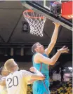  ?? SHANNON BRODERICK/AP ?? New Mexico’s Joe Furstinger, right, shoots over Wyoming’s Hayden Dalton during the Lobos’ road victory Tuesday night.