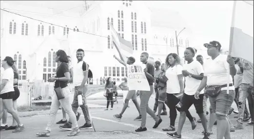  ?? (Stabroek News file photo) ?? Participan­ts in the 2019 parade walk by the St George’s Cathedral