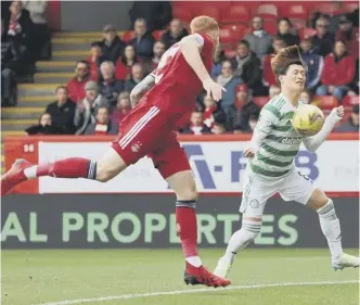  ?? ?? 0 Kyogo Furuhashi chests the ball home to put Celtic ahead at Pittodrie in the 11th minute