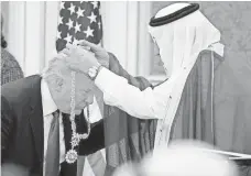  ?? EVAN VUCCI, AP ?? Saudi King Salman presents President Trump with a medal in Riyadh on May 20.