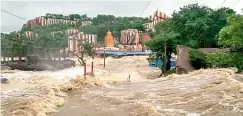  ?? — DC ?? Top: Eight gates (left) were lifted at the Sriramsaga­r project on Saturday. Officials opened all 42 gates later at night as the flow of water increased. Right: The Manjira in full flow at Edupayalu, near the city. Three persons were reported killed in...