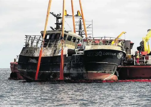  ??  ?? SALVAGE: The wreck of the Western Isles crab boat MFV Louisa, which sank on April 9 last year, being raised from the sea bed