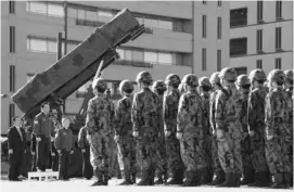  ??  ?? Japanese Prime Minister Yoshihiko Noda ( 2nd from left) addresses soldiers while in front of a Patriot Advanced Capability-3 (PAC-3) missile launcher at the Defense Ministry in Tokyo. Japan issued the order to shoot down a North Korean rocket if it...