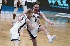  ?? MICHAEL CONROY — THE ASSOCIATED PRESS ?? Gonzaga forward Drew Timme (2) celebrates with Gonzaga guard Martynas Arlauskas (5) after an Elite 8game against Southern California in the NCAA men’s college basketball tournament at Lucas Oil Stadium, Tuesday in Indianapol­is. Gonzaga won 85-66.