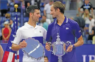  ?? Associated Press ?? Trophy ceremony: Novak Djokovic, of Serbia, left, and Daniil Medvedev, of Russia, talk during the trophy ceremony after the men's singles final of the U.S. Open tennis championsh­ips Sunday in New York.