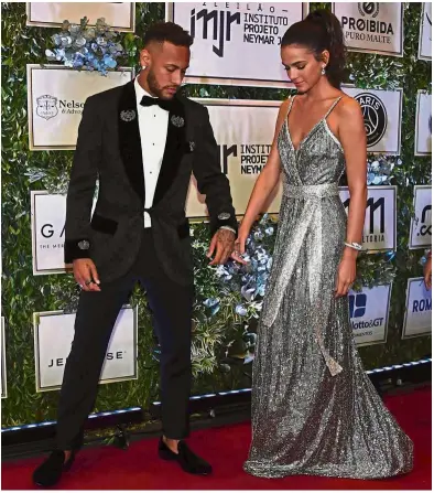 ?? — AFP ?? Hot couple: Brazilian Neymar (left) and his girlfriend Bruna Marquezine arriving at a charity auction for the Neymar Jr Institute in Sao Paulo, Brazil, on Thursday.