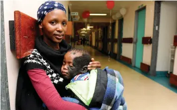  ?? PICTURE HENK KRUGER/ANA ?? STARTING TO SMILE: Thuliswa Nombewu and son Luphiwo, 2, wait at Tygerberg Hospital. Some 41 children with facial disorders will undergo surgery at Tygerberg Academic Hospital during Smile Week.