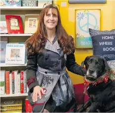  ?? JENELLE SCHNEIDER/PNG ?? Deb McVittie, owner of 32 Books, seen with her dog Gem, says women ‘find the gentler side of the situation’ when it comes to business.