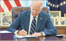  ?? Mandel ngan/aFP/tns ?? President Joe Biden signs the American Rescue Plan on March 11 in the Oval Office of the White House in Washington, D.C. Biden signed the $1.9 trillion economic stimulus bill, which included extra benefits for the unemployed.