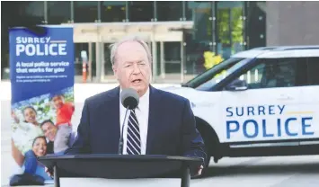  ?? NICK PROCAYLO/FILES ?? Mayor Doug McCallum stands in front of a prototype of a new Surrey Police vehicle. He campaigned on a promise to replace the RCMP with a local force.