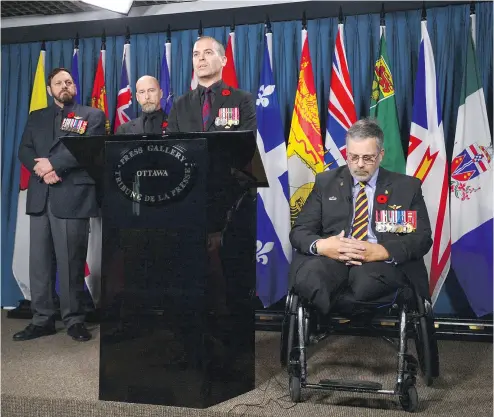  ?? SEAN KILPATRICK / THE CANADIAN PRESS ?? Afghanista­n veteran and retired major Mark Campbell, right, joins a group of veterans on Parliament Hill on Thursday. No group has the power to inflict damage on a government like irate veterans, writes John Ivison.