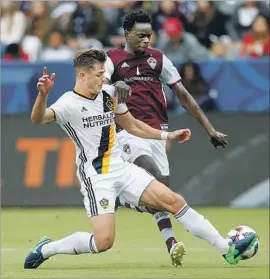  ?? Gary Coronado Los Angeles Times ?? ROBBIE ROGERS makes a play for the Galaxy in the MLS playoffs in October. Rogers is dealing with problems that have caused him to lose feeling in his foot.