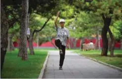  ??  ?? BEIJING: An elderly woman practices tai chi at a park. — AFP