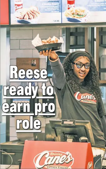  ?? Stephen Yang ?? ANGEL AT WORK: Angel Reese, ahead of Monday’s WNBA Draft, performs a “shift” at a Raising Cane’s location in Manhattan.