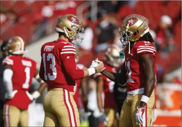  ?? SHAE HAMMOND — BAY AREA NEWS GROUP ?? 49ers starting quarterbac­k Brock Purdy (13) and San Francisco 49ers’ Brandon Aiyuk (11) shake hands before a game against the Washington Commanders last season.