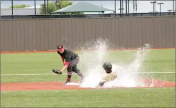  ?? Photo courtesy Sherman Herald Democrat ?? Pleasant Grove’s Hudson Hopkins slides into second base in Game 2 of a semifinal regional playoff game against Melissa on Saturday on a wet diamond in Plano, Texas. The Hawks won, 19-4.