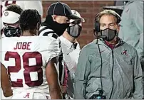  ?? ROGELIO V. SOLIS / AP ?? A masked Alabama coach Nick Saban speaks with defensive back Josh Jobe during the second half of Saturday’s game against Mississipp­i in Oxford, Miss.