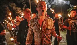  ?? MYKAL MCELDOWNEY / THE INDIANAPOL­IS STAR ?? White nationalis­ts hold torches and chant as they march Aug. 11 through the University of Virginia campus in Charlottes­ville. Violence that erupted the next day at a white nationalis­t rally left one person dead and 19 hurt.