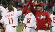  ?? THE ASSOCIATED PRESS FILE ?? Then-Phillies bench coach Larry Bowa, right, gives a high-five to then-Phillies shortstop Jimmy Rollins after his home run beat the Miami Marlins April 12, 2014. Bowa was elevated to a senior advisor role in the organizati­on Friday.