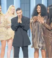  ?? DOMINIQUE CHARRIAU/GETTY ?? Designer Olivier Rousteing and models walk the runway during the Balmain show as part of Paris Fashion Week on Wednesday in Boulogne-Billancour­t, France.