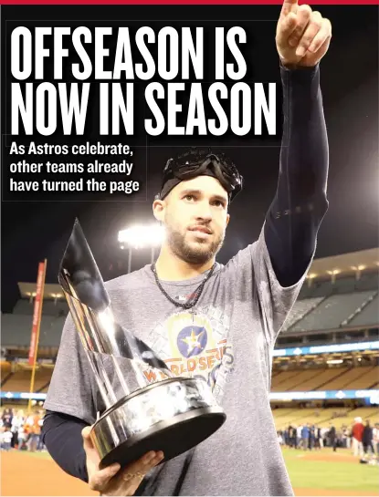  ??  ?? Astros outfielder George Springer displays the trophy he was awarded after being voted the World Series MVP. | GETTY IMAGES