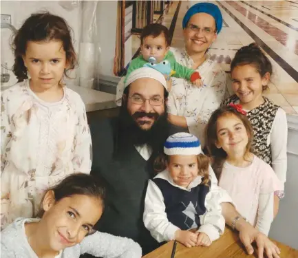  ??  ?? RAZIEL SHEVACH, whom a terrorist murdered on Tuesday, is surrounded by his wife and six children in this recent photograph.