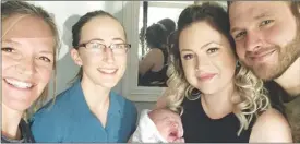  ?? Special to The Herald ?? New parents and baby are visited at their home by midwife Susie Lobb of the South Okanagan Maternity Centre (left) and family medicine resident Dr. Emma Polle.