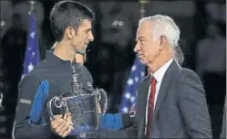  ?? AFP ?? He receives the US Open champions trophy from John McEnroe, but wished Pete Sampras was there.