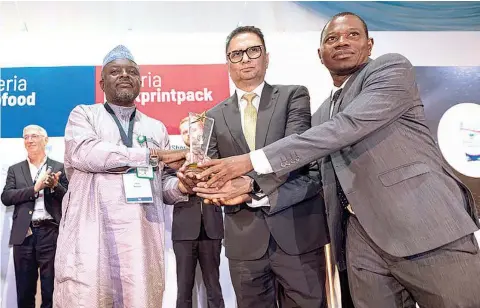  ?? ?? Head of Food Desk, Standard Organisati­on of Nigeria ( SON), Yunusa Mohamad ( left); presenting the Micronutri­ent Fortificat­ion Index Top Five Tier Award and the Fortificat­ion Excellence Award to Dangote Sugar as a leading brand in food fortificat­ion and excellence to the Group Managing Director/ CEO, Dangote Sugar Refinery Plc, Ravindra Singhvi and Head Quality Assurance, Dangote Sugar Refinery Plc, Adepoju Aderemi at the 2024 edition of Technoserv­e MFI Annual Awards and Millers for Nutrition Launch awards ceremony in Lagos… recently.