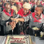  ??  ?? Robert, Grace and Chatunga Mugabe cutting a cake at the Zimbabwean president’s birthday celebratio­n in 2011.