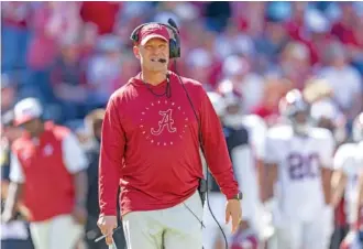  ?? AP PHOTO/VASHA HUNT ?? Alabama football coach Kalen DeBoer, who left Washington in January to take over the Crimson Tide after Nick Saban retired, walks the field as he watches during Saturday’s A-Day spring game in Tuscaloosa.