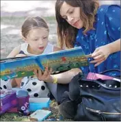  ?? Francine Orr
Los Angeles Times ?? CECI BASTIDA reads with her 3-year-old daughter, Yamila Kun, during the Festival of Books at USC.