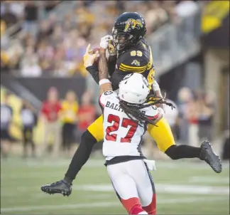  ?? The Canadian Press ?? Hamilton Tiger-Cats receiver Jalen Saunders has the ball batted away by Ottawa Redblacks defensive back Sherrod Baltimore (27) during CFL action in Hamilton, Ont., on Friday night. The Redblacks won 37-18.