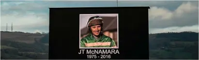  ??  ?? A tribute to the late JT McNamara on the big screen ahead of the JT McNamara National Hunt Challenge Cup Amateur Riders’ Novices’ Steeple Chase at Cheltenham yesterday