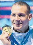  ?? FOTO: DPA ?? Sechs Mal Gold: Zahnspange­nträger Calaeb Dressel ist der neue Star im Männerschw­immen.