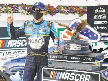  ?? MATT SLOCUM/AP ?? Kevin Harvick celebrates in the winners circle after winning the NASCAR Cup Series auto race at Pocono Raceway on Saturday, his first win in 39 career starts at Long Pond.