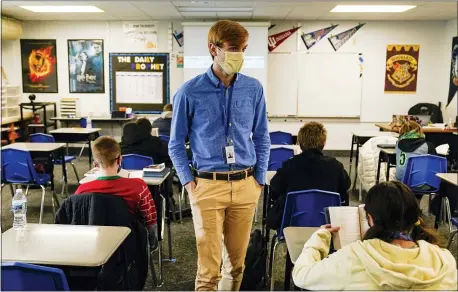  ?? MICHAEL CONROY — THE ASSOCIATED PRESS ?? Cooper Hanson, a substitute teacher at the Greenfield Intermedia­te School in Greenfield, Ind., on Dec. 10, also is a student at Hanover College. He is one of several college students being recruited to work as substitute teachers in schools during the pandemic.