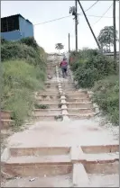  ??  ?? The steep slope with stairs makes it hard for elderly residents to get to the clinic for health check-ups.