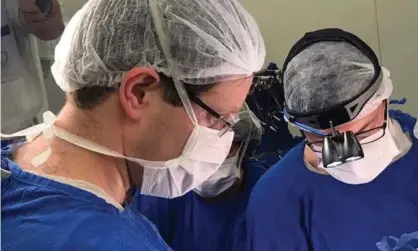  ??  ?? Doctors perform the womb transplant on Brazil in 2017. Photograph: Reuters