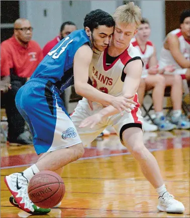  ?? DANA JENSEN/THE DAY ?? St. Bernard’s Zach Clark (23) knocks the ball way from Putnam’s Jordan Marks (13) during Thursday’s boys’ basketball game at Montville. St. Bernard won 63-36.