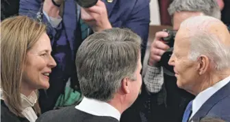  ?? SAUL LOEB/AFP VIA GETTY IMAGES ?? Justices Amy Coney Barrett and Brett Kavanaugh talk with President Joe Biden at the State of the Union address last Tuesday.