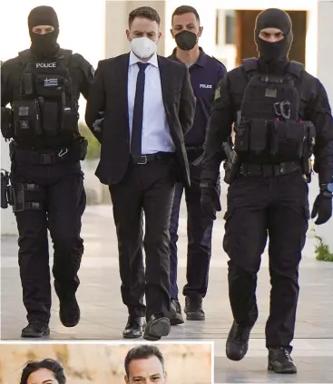  ?? ?? In court: The helicopter pilot is escorted by armed police to trial in Athens yesterday