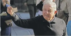  ?? EDUARDO VERDUGO/AP ?? Mexico’s President Andres Manuel López Obrador shows his ID card last Sunday after voting in a national referendum on whether he should end his six-year term early.