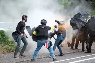  ?? (AP Photo/alex Milan Tracy, File) ?? Members of the far-right group Proud Boys and anti-fascist protesters spray bear mace at each other during clashes between the politicall­y opposed groups Aug. 22, 2021, in Portland, Ore. Over the past decade, Oregon experience­d the sixth-highest number of extremist incidents in the nation, despite being 27th in population, according to an Oregon Secretary of State report. Now, the state Legislatur­e is considerin­g a bill that, experts say, would create the nation’s most comprehens­ive law against paramilita­ry activity.