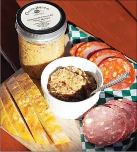  ?? SHELORA SHELDAN/Special to The Herald ?? A collaborat­ive effort between Farmersdot­ter and Cannery Brewing, this Naramata Nut Brown Ale Honey Mustard boasts a delightful balance between sweetness and maltiness, and pairs well with sausage rolls, cheese and charcuteri­e platters, or makes a...