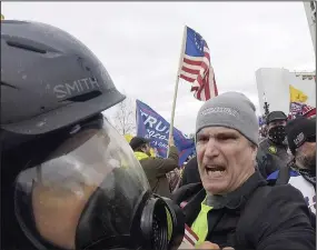  ?? (AP/Julio Cortez) ?? Alan William Byerly (right) is seen attacking an Associated Press photograph­er during a riot at the U.S. Capitol in Washington on Jan. 6, 2021.