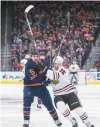  ?? BRACKEN/AP AMBER ?? Joey Anderson, right, works against the Oilers’ Cody Ceci during the third period on Thursday.