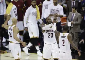  ?? TONY DEJAK — THE ASSOCIATED PRESS ?? Cleveland Cavaliers forward LeBron James (23) and teammate Kyrie Irving (2) celebrate during the first half against the Golden State Warriors in Game 4 of basketball’s NBA Finals in Cleveland, Friday.