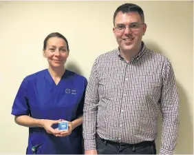  ??  ?? > Specialist nurse in gastroente­rology Angela Green and consultant Jeff Turner carry out the procedure at University Hospital Llandough